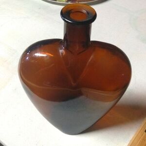 Heart-shaped amber colored vintage glass Paul Mason bottle